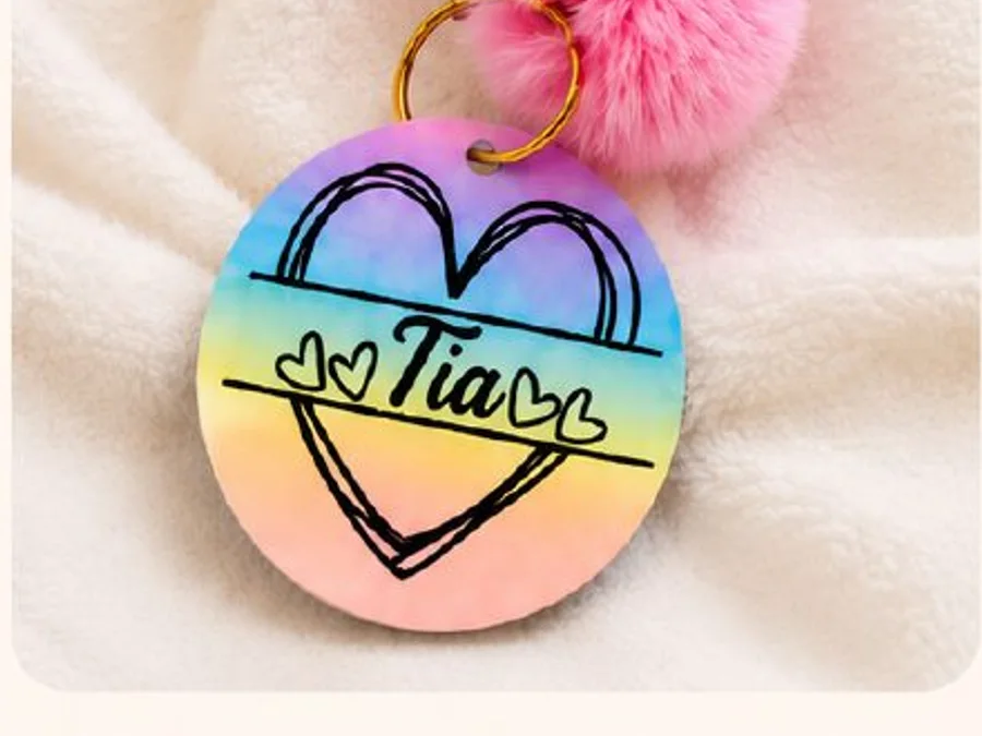 Round personalized backpack tag with rainbow colors and pom-pom